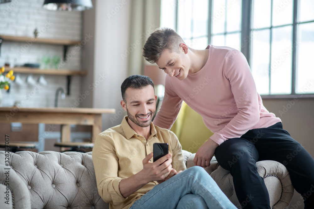 Gay couple looking enjoyed talking with friends online Gay couple looking enjoyed talking with friends online