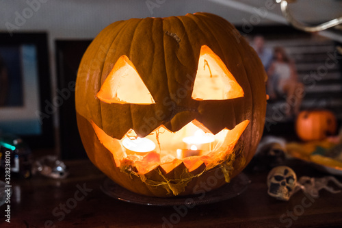 Jack-o'-lantern (dribbling). Beautiful fresh carved pumpkin close up lighten with candles. Typical scary halloween decoration, october 31. Irish legend of Stingy Jack. photo