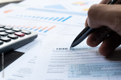 United state 1040 individual tax return form with pen