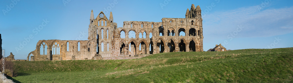 Ancient abbey ruins with gothic architecture in rural landscape