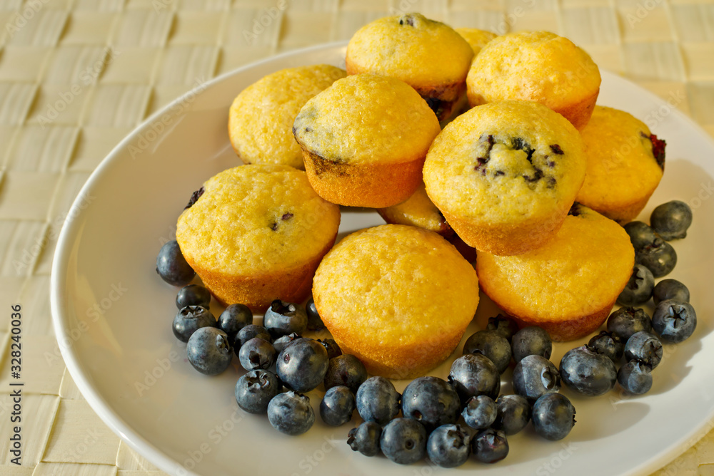 Batch of fresh baked corn muffins with blueberries
