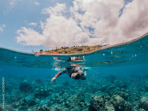 Man snorkeling in the sea, Lipah beach, Amed, Bali. photo