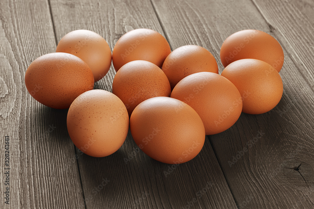 Fresh brown chicken eggs with shallow depth of field on the surface of an old wooden rustic table Fresh brown chicken eggs with shallow depth of field on the surface of an old wooden rustic table