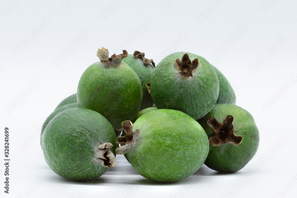 Green feijoa fruits isolated on white background. Scientific name Acca sellowiana. Top view. Healthy and balanced diet eating concept. Fresh fruits concept. Green feijoa fruits isolated on white background. Scientific name Acca sellowiana. Top view. Healthy and balanced diet eating concept. Fresh fruits concept.