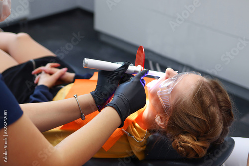 Young girl is made installing dental braces