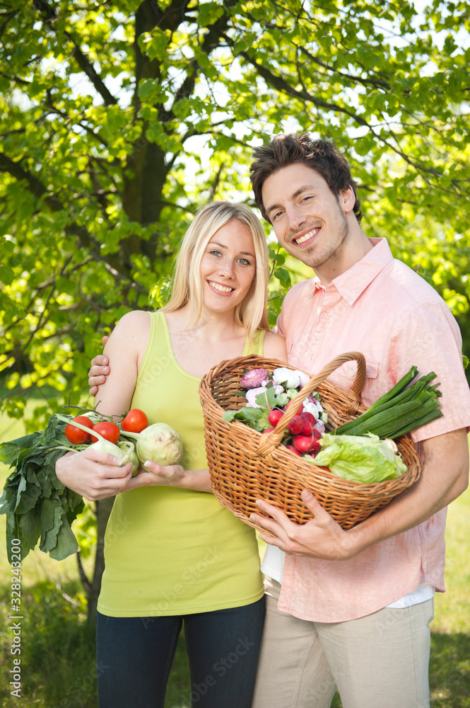 Farmers. Happy young couple with fresh organic food.