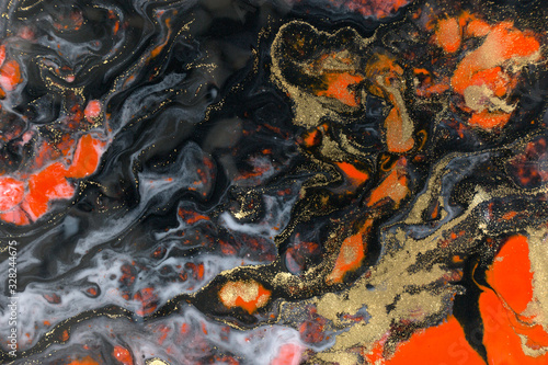Red  black and gold paint liquid background. Abstract marble texture.