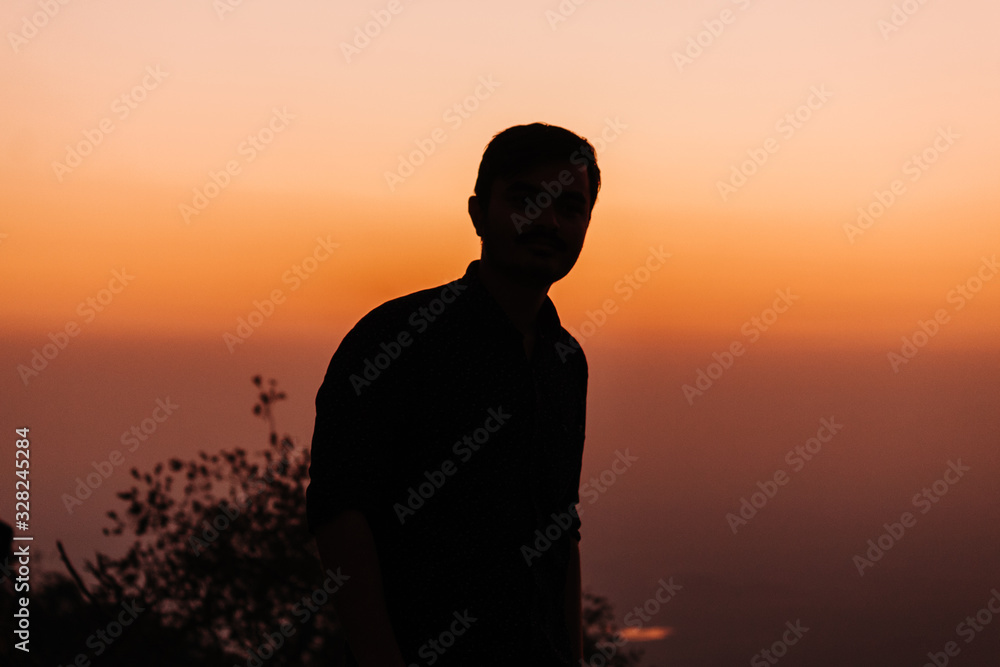 Silhouette of a man during sunset at Sunset Point in Mount Abu, Rajasthan, India