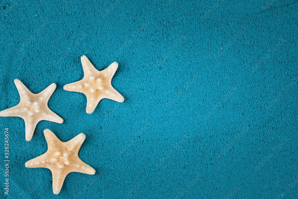 Starfish on the blue sand copy space. Colored sand. Starfish on the blue sand copy space. Colored sand.