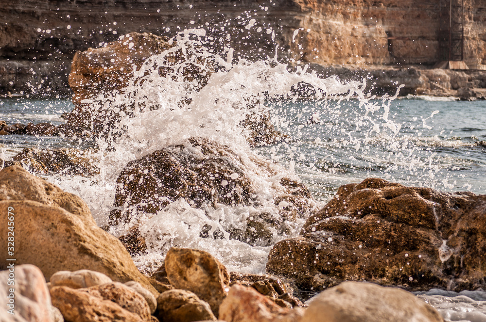Splitting waves against picturesque rocks in the sea