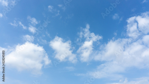 Beautiful white fluffy clouds on vivid blue sky in a sunny day