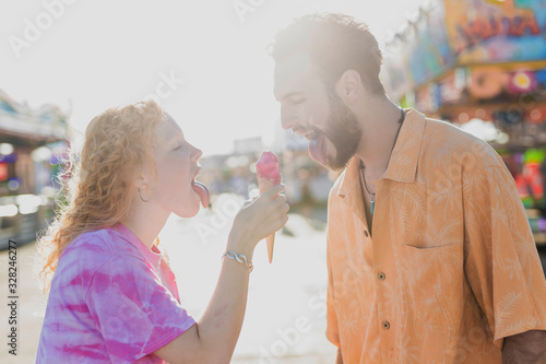 Side view couple eating ice cream together