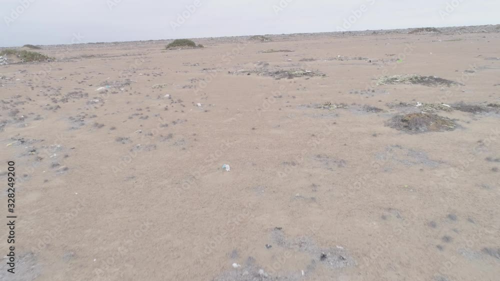 Pullback aerial drone view move of garbage in the Sechura Desert in Lambayeque Region, Peru
