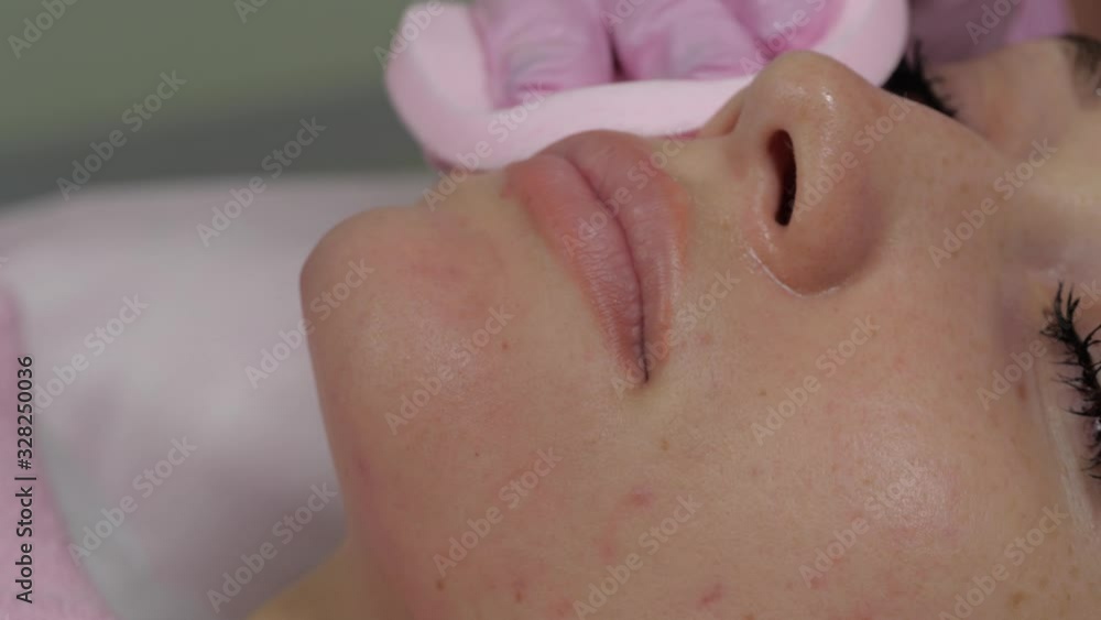 Pink sponge on a woman's face. Pink sponge on a woman's face.