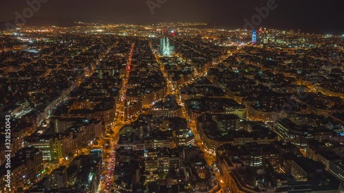 Night Hyperlapse / Motion Time lapse of Barcelona City Sagrada Familia Skyline. Night Barcelona cityscape aerial panorama. Cityscape with typical urban octagon blocks. Catalonia, Spain. photo