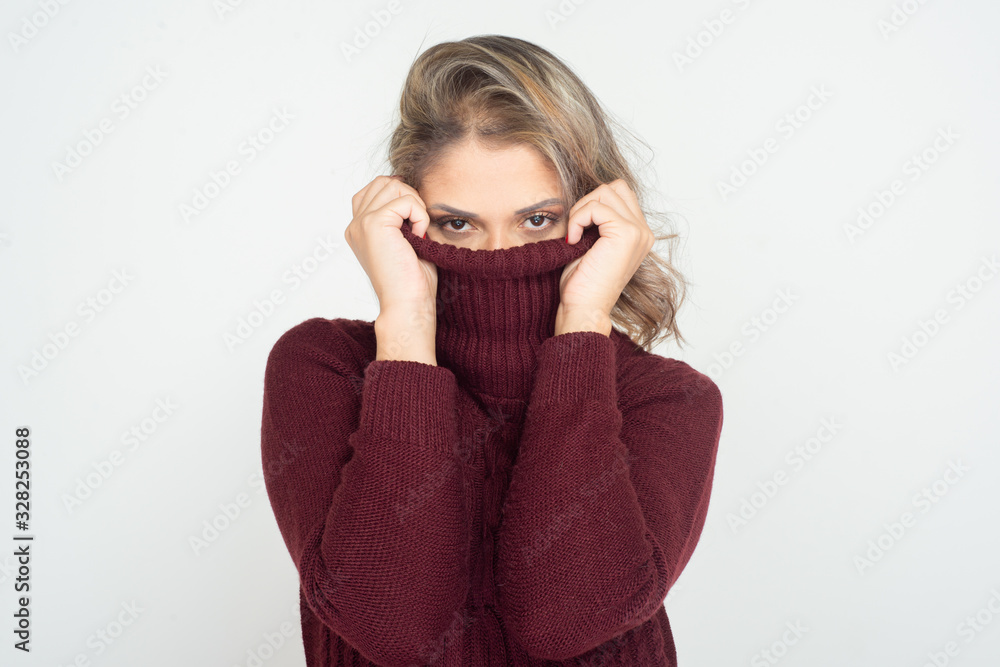 Woman wearing turtleneck and looking at camera. Attractive young blonde woman wearing maroon turtleneck and looking at camera isolated on white background. Beauty concept Woman wearing turtleneck and looking at camera. Attractive young blonde woman wearing maroon turtleneck and looking at camera isolated on white background. Beauty concept