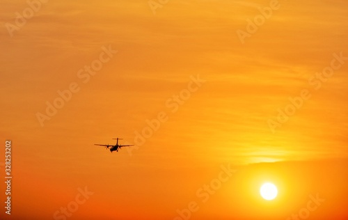 Silhouette Turboprop Aircraft Flying Landing Against The Sun © asiraj