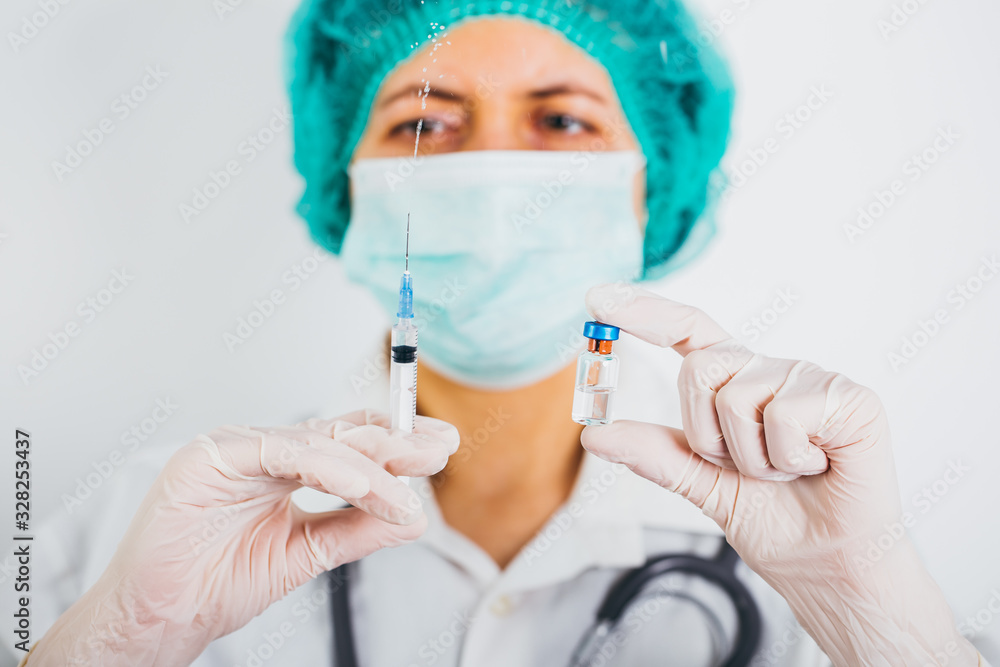 Vaccine bottle and syringe in a doctors hands close-up. Ncov-19/ Coronavirus concept. Vaccine bottle and syringe in a doctors hands close-up. Ncov-19/ Coronavirus concept.