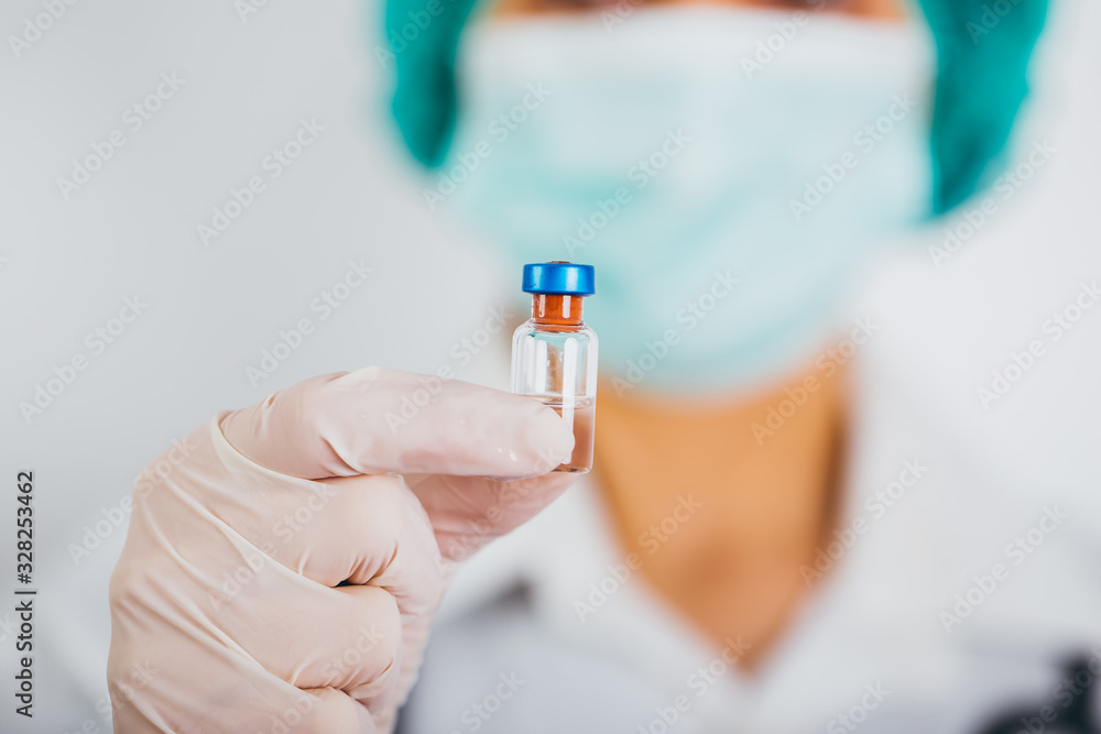Vaccine bottle and syringe in a doctors hands close-up. Ncov-19/ Coronavirus concept. Vaccine bottle and syringe in a doctors hands close-up. Ncov-19/ Coronavirus concept.