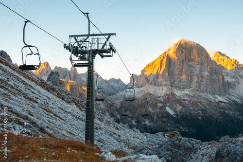 Ski lifts along the ski slope near the Cinque Torri mountains the background Tofane mountain near the famous town of Cortina d'Ampezzo, Dolomites Mountains photo