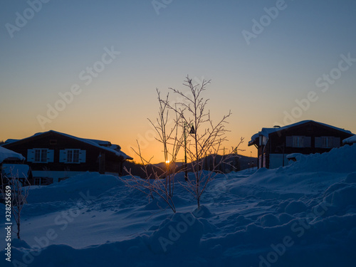 Dawn in the ski resort Mountain Salanga. Lyrical winter landscape. Frosty morning in Siberia photo