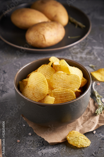 potato chips in a gray bowl on a gray background