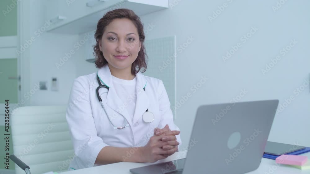 Friendly smile on face of nice female doctor, healthcare services in clinic Friendly smile on face of nice female doctor, healthcare services in clinic