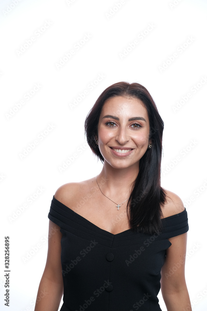 A large portrait of a middle-aged woman (30-35 years old) with dark hair and brown eyes in a black dress on a light background. A large portrait of a middle-aged woman (30-35 years old) with dark hair and brown eyes in a black dress on a light background.