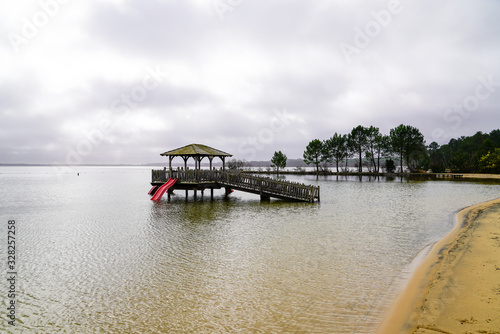 Maguide lake forest wooden hut on stilts on sand beach water in cloudy day