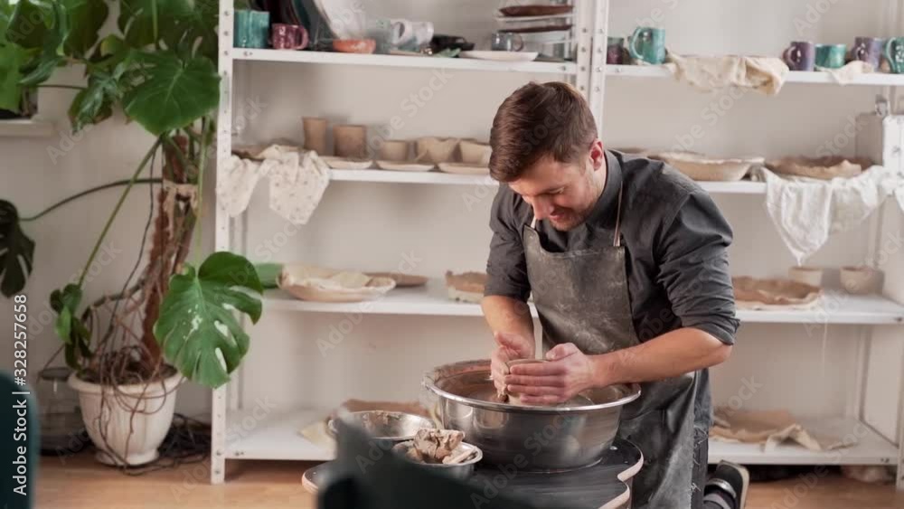 a male potter first tries to work on a potter's wheel himself a male potter first tries to work on a potter's wheel himself