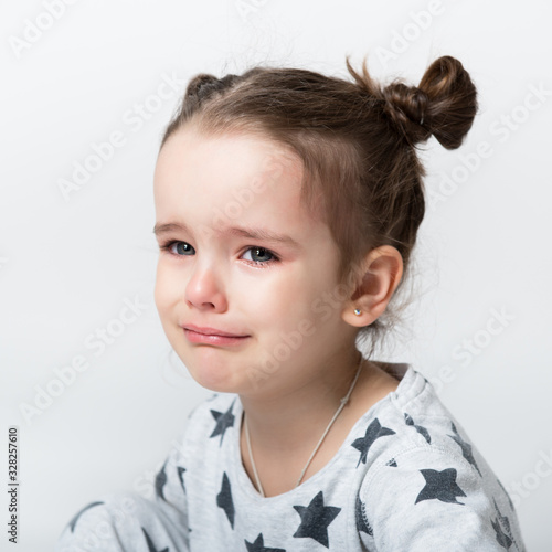 Crying little girl. Upset kid. Sad kid portrait. Cute little girl crying and does not want to go in bed at night