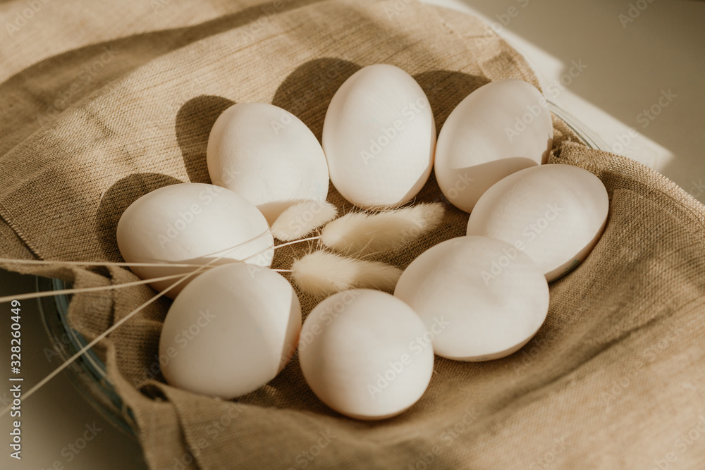 Organic white eggs of chicken on brown sack for background texture in natural light. Easter concept. Concept of organic natural farming. Organic white eggs of chicken on brown sack for background texture in natural light. Easter concept. Concept of organic natural farming.