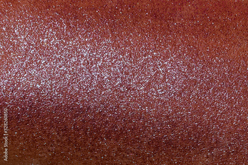 Blended highlighter on skin surface full frame texture.