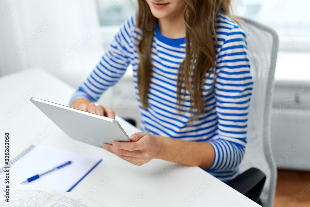Fototapeta premium education, technology and people concept - close up of student girl using tablet pc computer at home