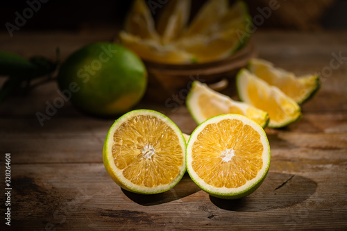 Beautiful color of green orange, on the wooden table indoor