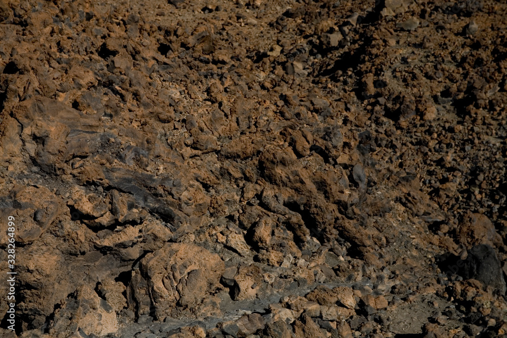 original brown natural background of volcanic congealed lava in close-up original brown natural background of volcanic congealed lava in close-up