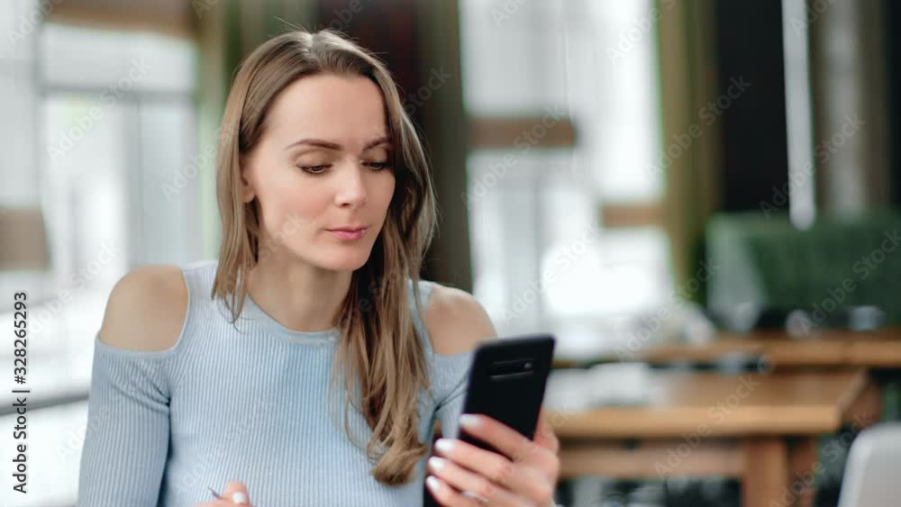 Lady enjoying lunch at cafe scrolling social networks on mobile. Close up shot on 4k RED camera Lady enjoying lunch at cafe scrolling social networks on mobile. Close up shot on 4k RED camera