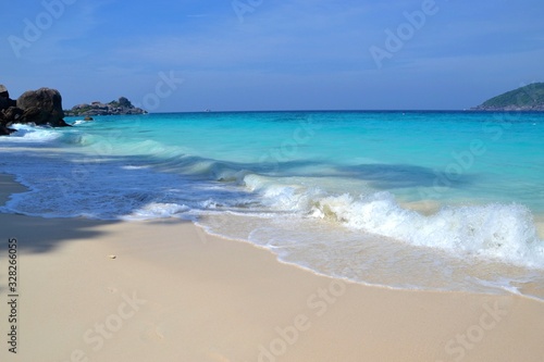 Picturesque exotic beach with white sand and blue clear water
