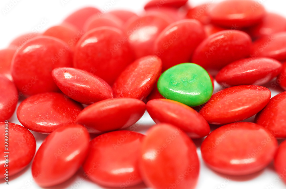 background many red and one green candy background many red and one green candy