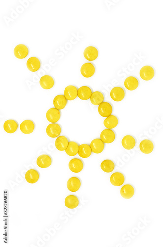 sun of many small round yellow candies isolated on a white background