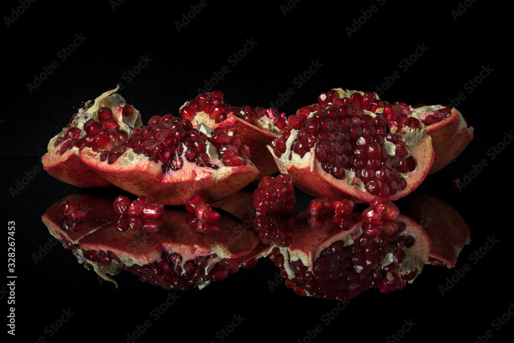 Garnet on a dark mirror table with reflection. Garnet on a dark mirror table with reflection.