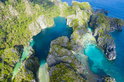 View from above, stunning aerial view of the Big Lagoon and the Small Lagoon, two beautiful bays of crystal clear water surrounded by rocky cliffs. Bacuit Bay, El Nido, Palawan, Philippines.