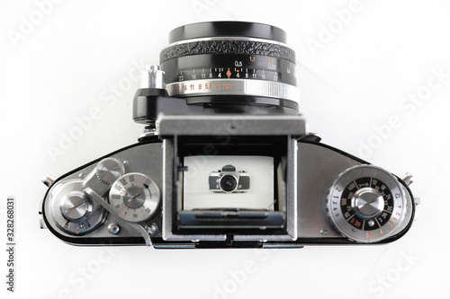The old German 35 mm SLR film camera with Lens 2,8 50 mm on a white background. photo