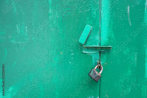 abstract background of old metal doors with a padlock close up
