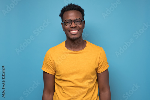 Black african american young man in yellow t-shirt with cheerful attitude photo
