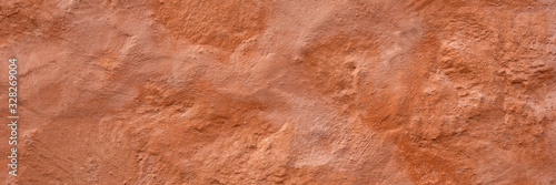 Panoramic texture of a plain wall painted with brown color. Panoramic brown background