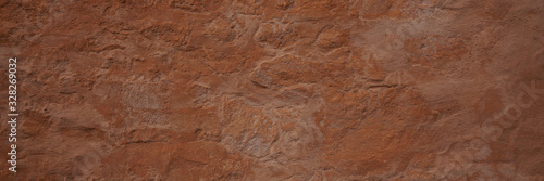 Panoramic texture of a plain wall painted with brown color. Panoramic brown background