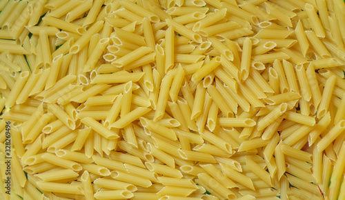 Macaroni background. Dry raw pasta.