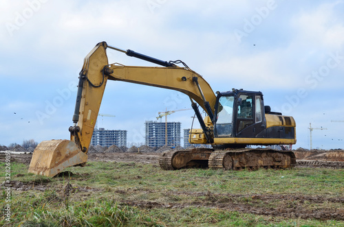 Tracked excavator working at a construction site during laying or replacement of underground storm sewer pipes. Installation of water main, sanitary sewer, storm drain systems - Image