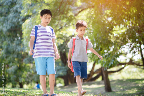 Two boy walking in a forest